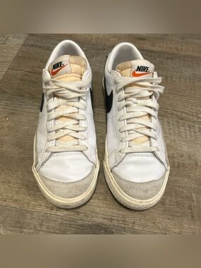 Nike White Leather Sneakers with Black Swoosh and Orange Tongue Logo